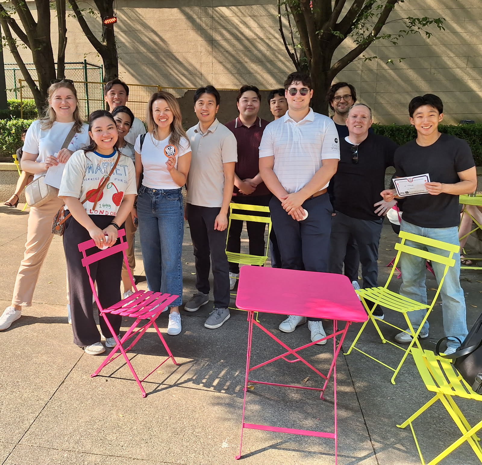 group of outdoor escape game players holding up certificates and stickers